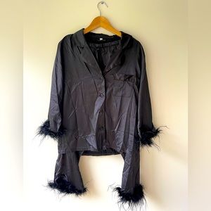 Black outfit with feather. Pants and top. Size indicated on label L. Fits S to L